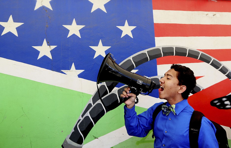 An activist chants during a protest at the U.S.-Mexico border during a Dream Act protest in Tijuana, Mexico in 2014.