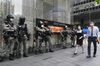 Riot police stand in front of a Louis Vuitton luxury goods store in the Central district in Hong Kong, China, on May 28.