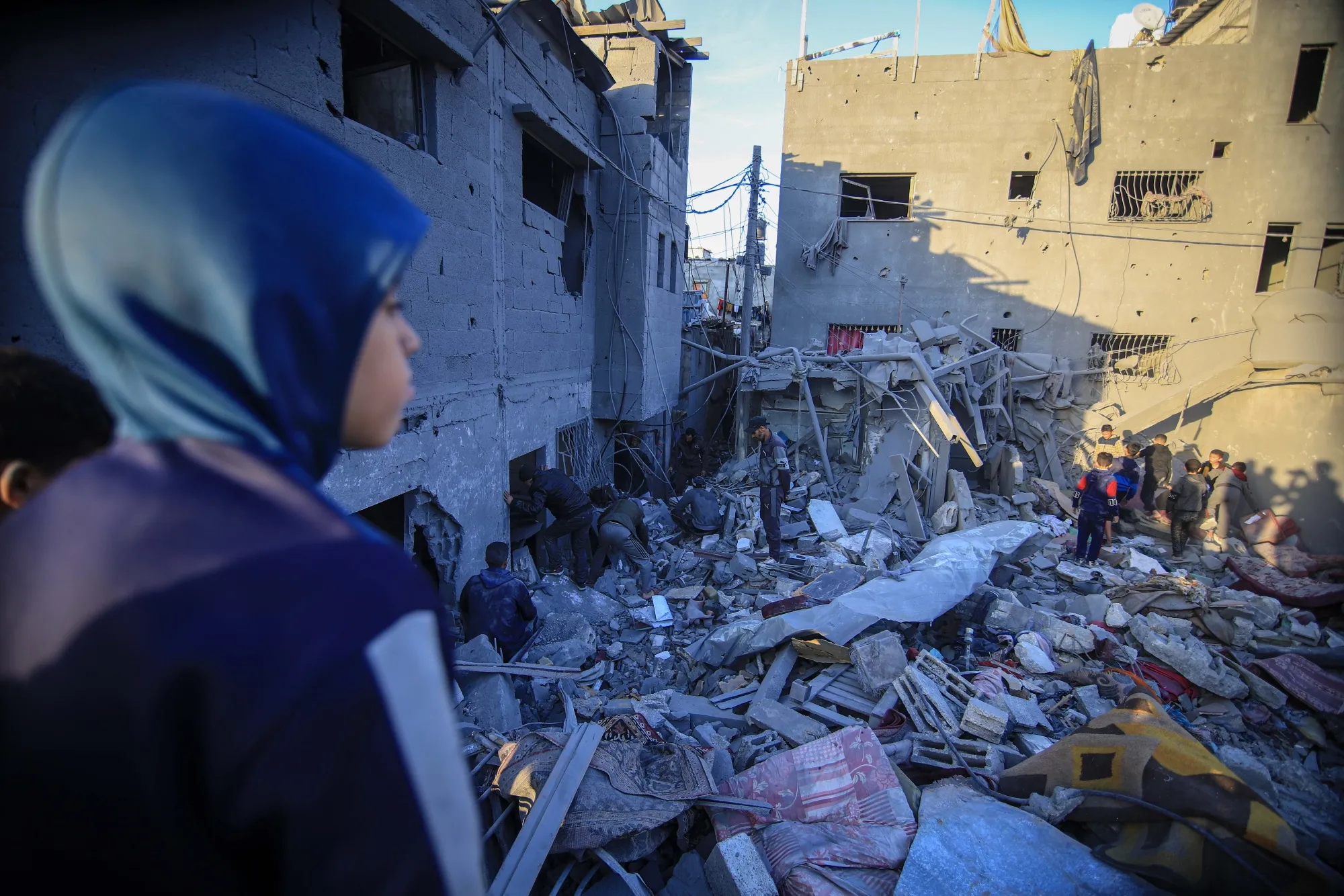 Palestinians search the rubble following an airstrike in Gaza.