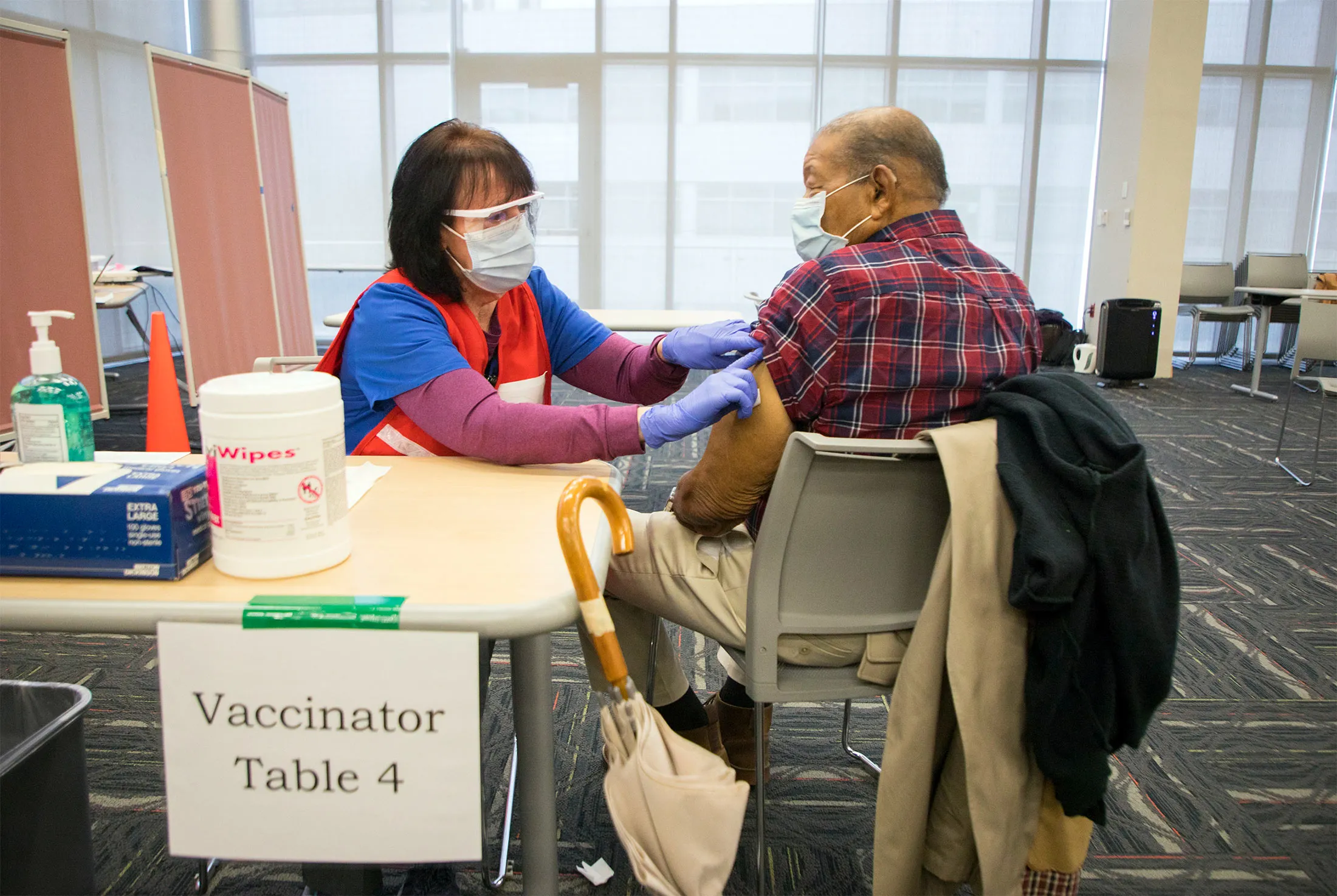 A health-care worker puts a bandage on man after he received the Moderna Covid-19 vaccine&nbsp;at the Durham County Department of Public Health in Durham, N.C., on&nbsp;Jan. 8.&nbsp;