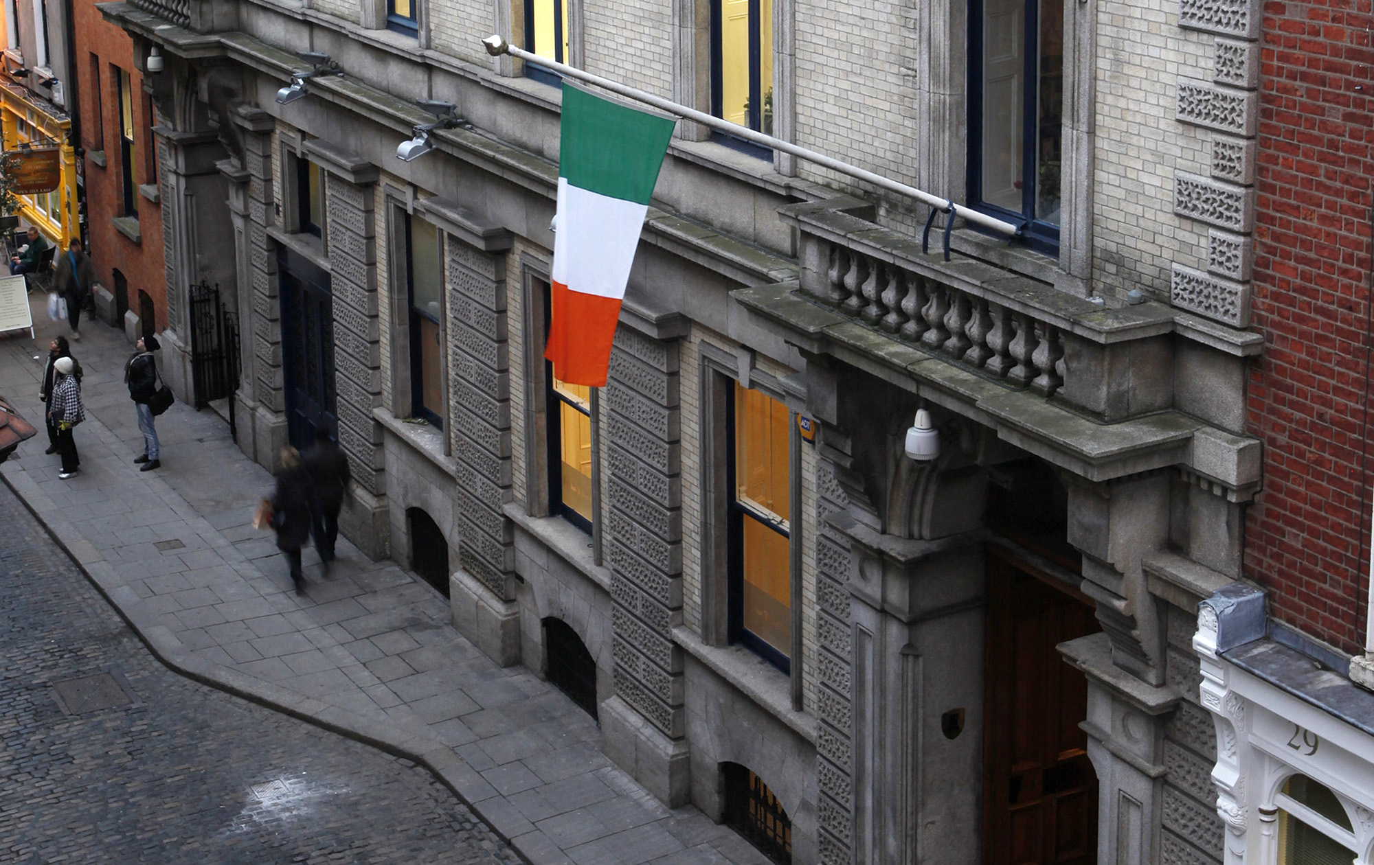 The Irish national flag flies from the flagpole at the Irish Stock Exchange in Dublin.