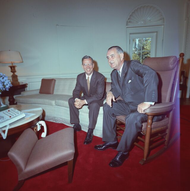 Fed Chair William McChesney Martin and President Lyndon Johnson sitting on a couch at a 1964 meeting at the White House.