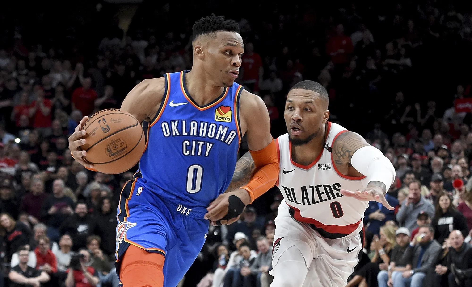 Russell Westbrook of OKC drives on Damian Lillard of the Portland Trail Blazers during a game on April 14, 2019.