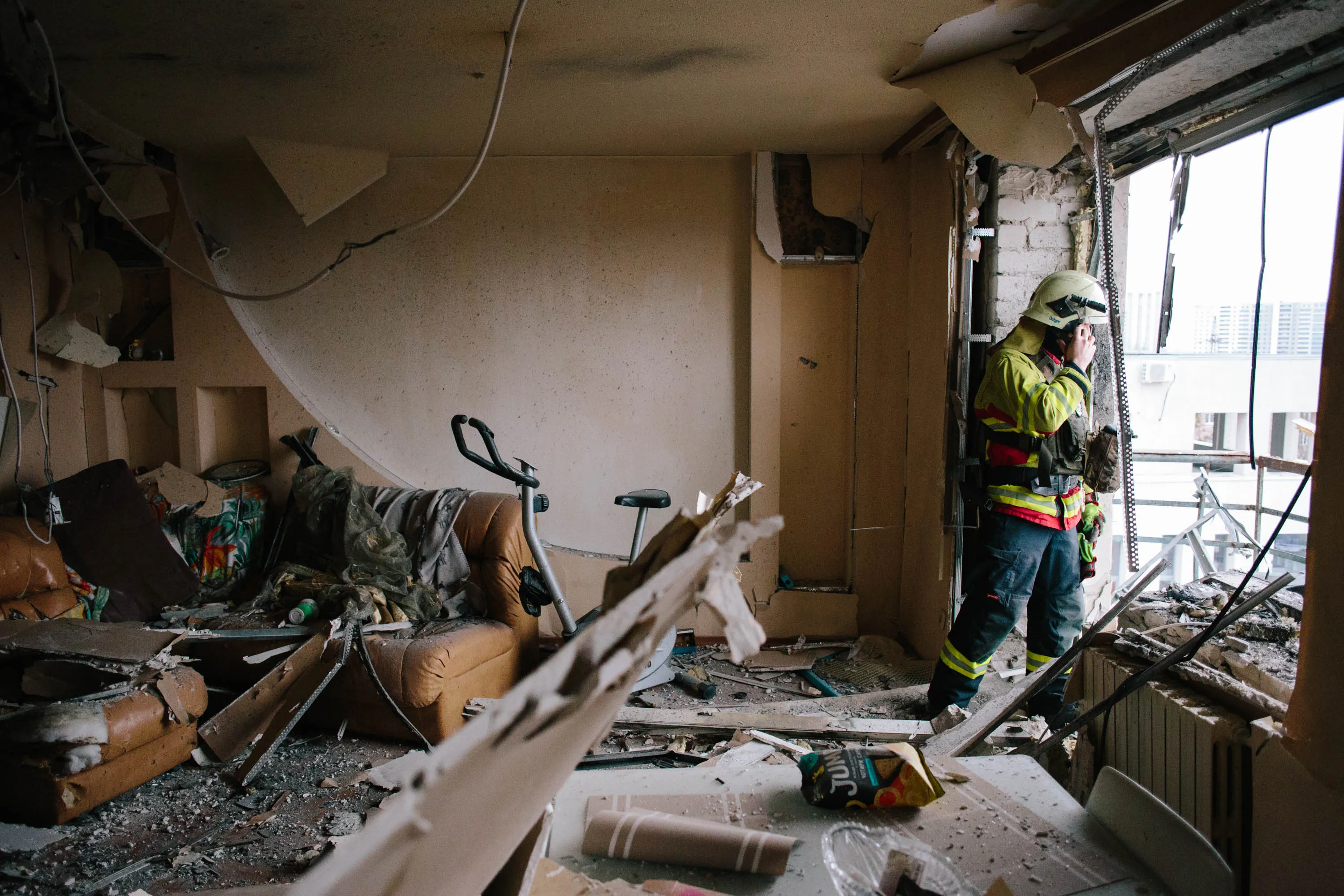 Rescuers inspect the balcony of the damaged apartment following a drone strike in Kharkiv, Ukraine, on March 2.