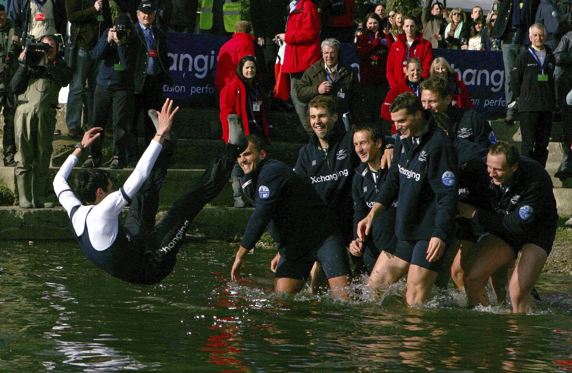 The Oxford crew, right, throw their cox Colin Groshong into the Thames at the 155th Boat Race, in London, Sunday March 29, 2009. Jumping into London’s River Thames has been the customary celebration for members of the winning crew in the annual Boat Race between storied English universities Oxford and Cambridge. Now researchers say it comes with a health warning. (AP Photo/Tom Hevezi, File)