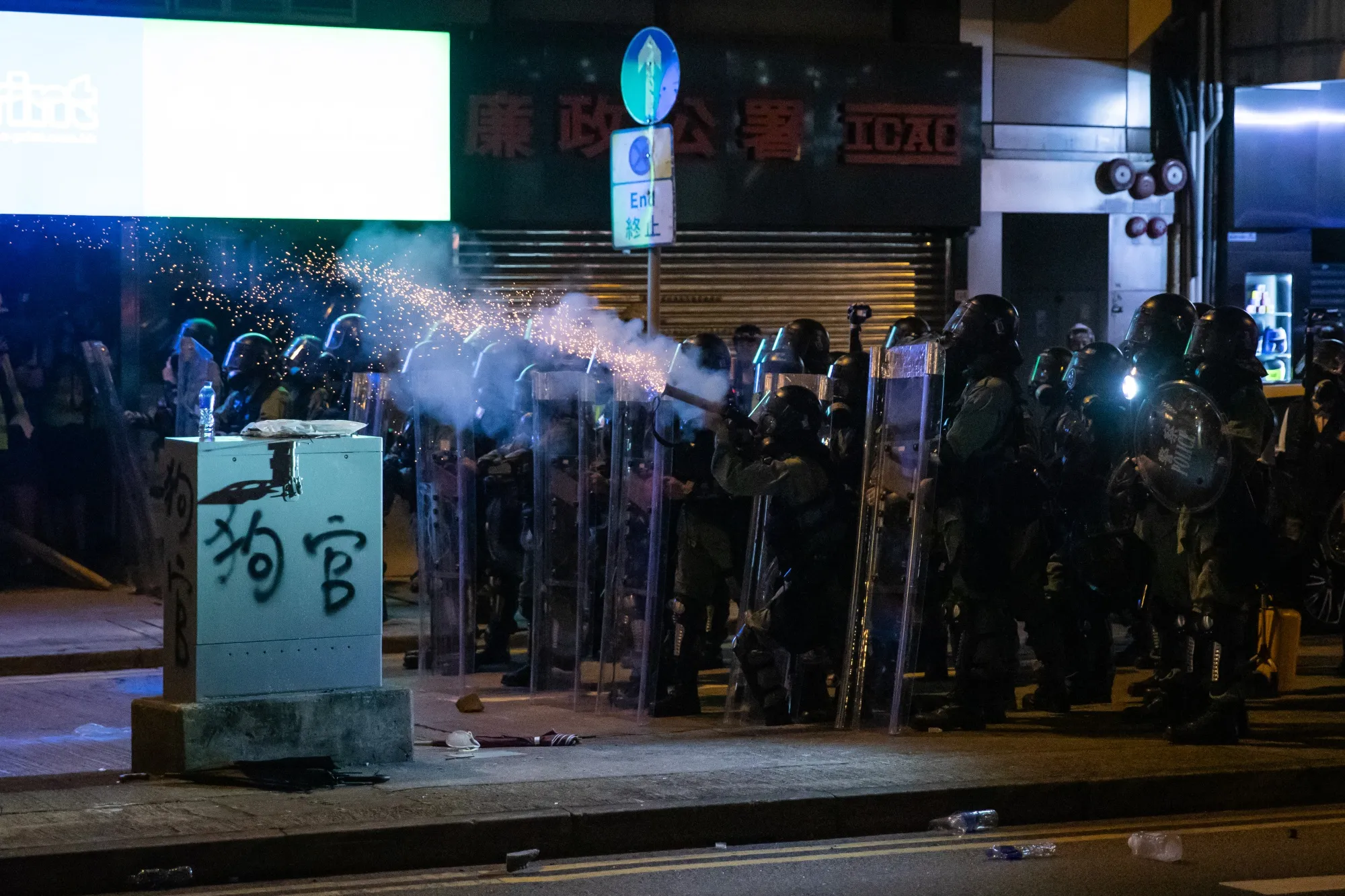 Riot Police fire tear gas to disperse demonstrators during a protest in Sheung Wan district of Hong Kong.