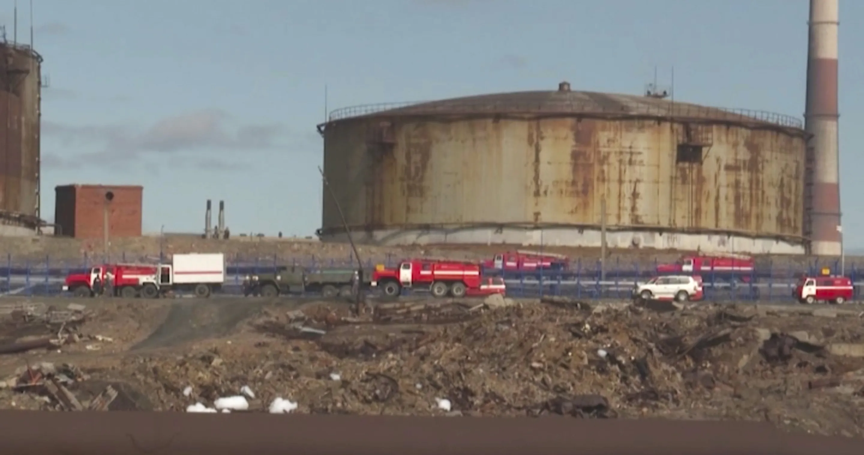 In this image taken from video provided by the RU-RTR Russian television&nbsp;Russian Emergency Situations Ministry trucks work at the scene of an oil spill at a power plant in an outlying section of the city of Norilsk, Russsia, June 3.