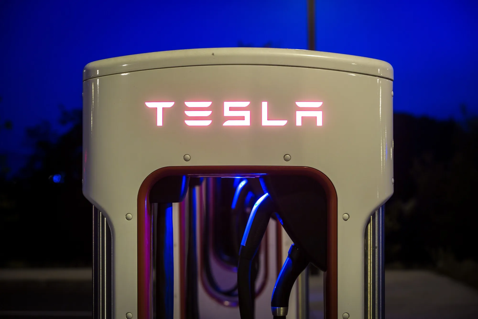 A Tesla Inc. Supercharger station at night.
