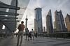 Pedestrians walk along an elevated walkway in the Lujiazui Financial District in Shanghai, China, on Monday, Sept. 4, 2017. The Chinese central bank's tight leash on liquidity is straining the bond market, with the benchmark sovereign yield climbing to near the highest level since April 2015.