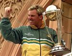 Australia's Shane Warne clenches his fist as he holds the Cricket World Cup Trophy on the team balcony at Lords after Australia defeated Pakistan by 8 wickets in the final of the Cricket World Cup, in London Sunday, June 20, 1999. Shane Warne, one of the greatest cricket players in history, has died. He was 52. Fox Sports television, which employed Warne as a commentator, quoted a family statement as saying he died of a suspected heart attack in Koh Samui, Thailand. (AP Photo/Rui Vieira, File)