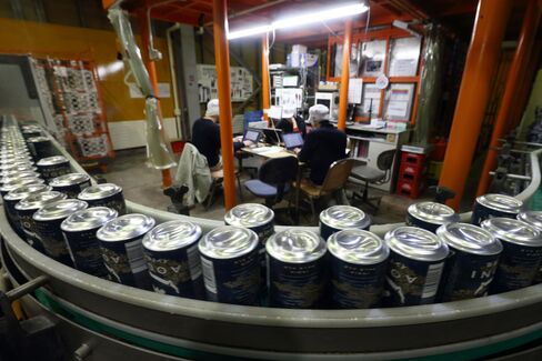 Cans of Indo no Aooni craft beer move along a conveyor on the production line of the Yo-Ho Brewing Co. brewery in Saku, Nagano Prefecture, on March 20, 2015. Photographer: Tomohiro Ohsumi/Bloomberg