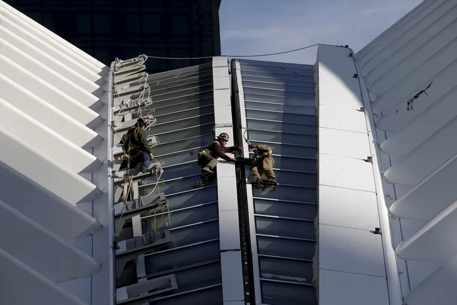 Men work on a portion of the retractable roof of the Oculus structure of the World Trade Center Transportation Hub in Manhattan, March 1, 2016.