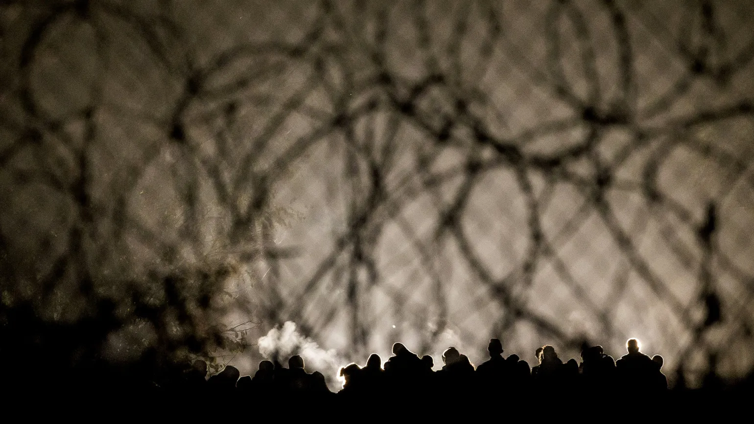 Migrants walk to the border with Hungary after arriving from Croatia, as police seal the border.
