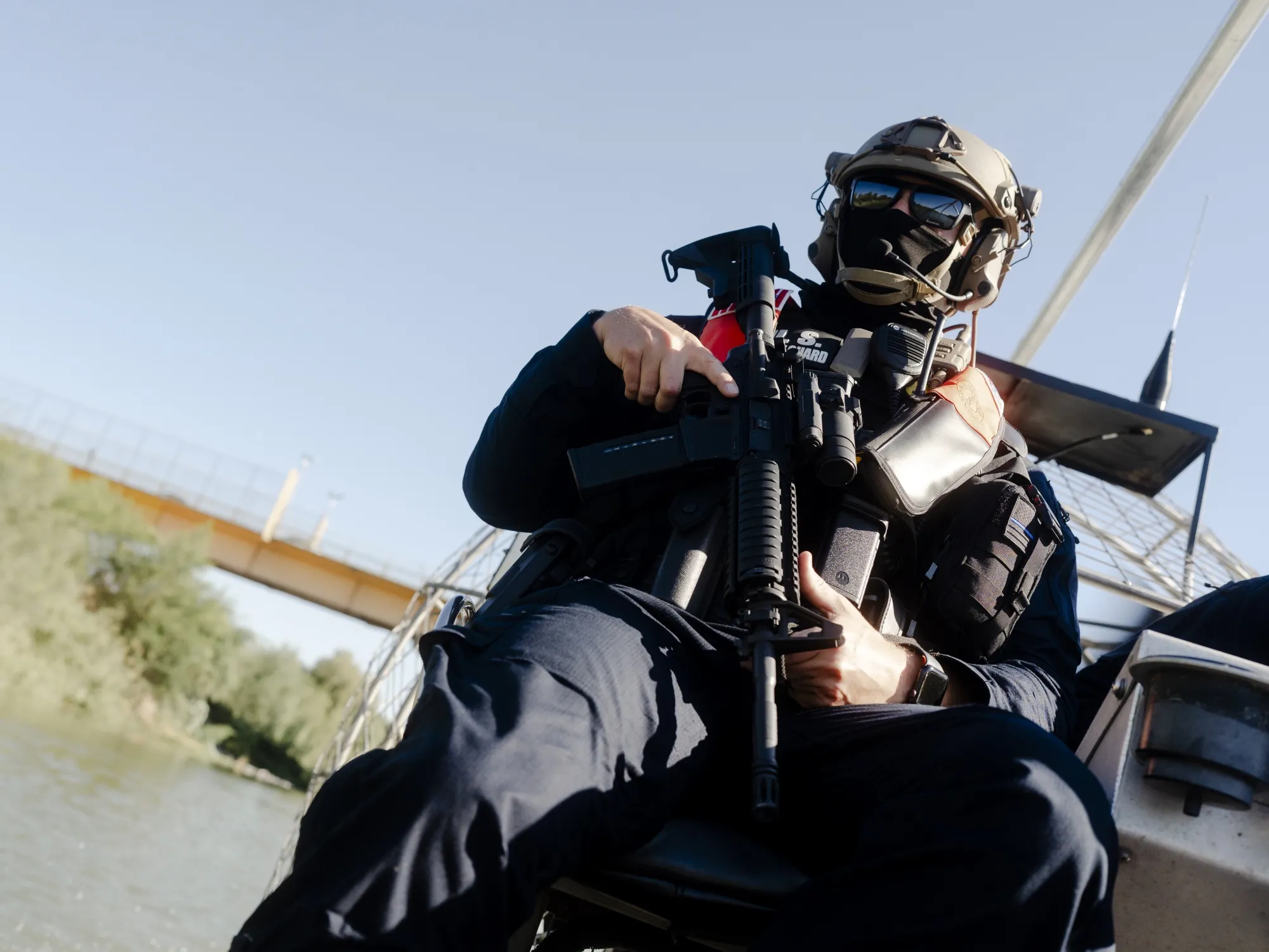 A US Coast Guard holds a rifle&nbsp;while patrolling the Rio Grande on an airboat as part of Operation River Wall.