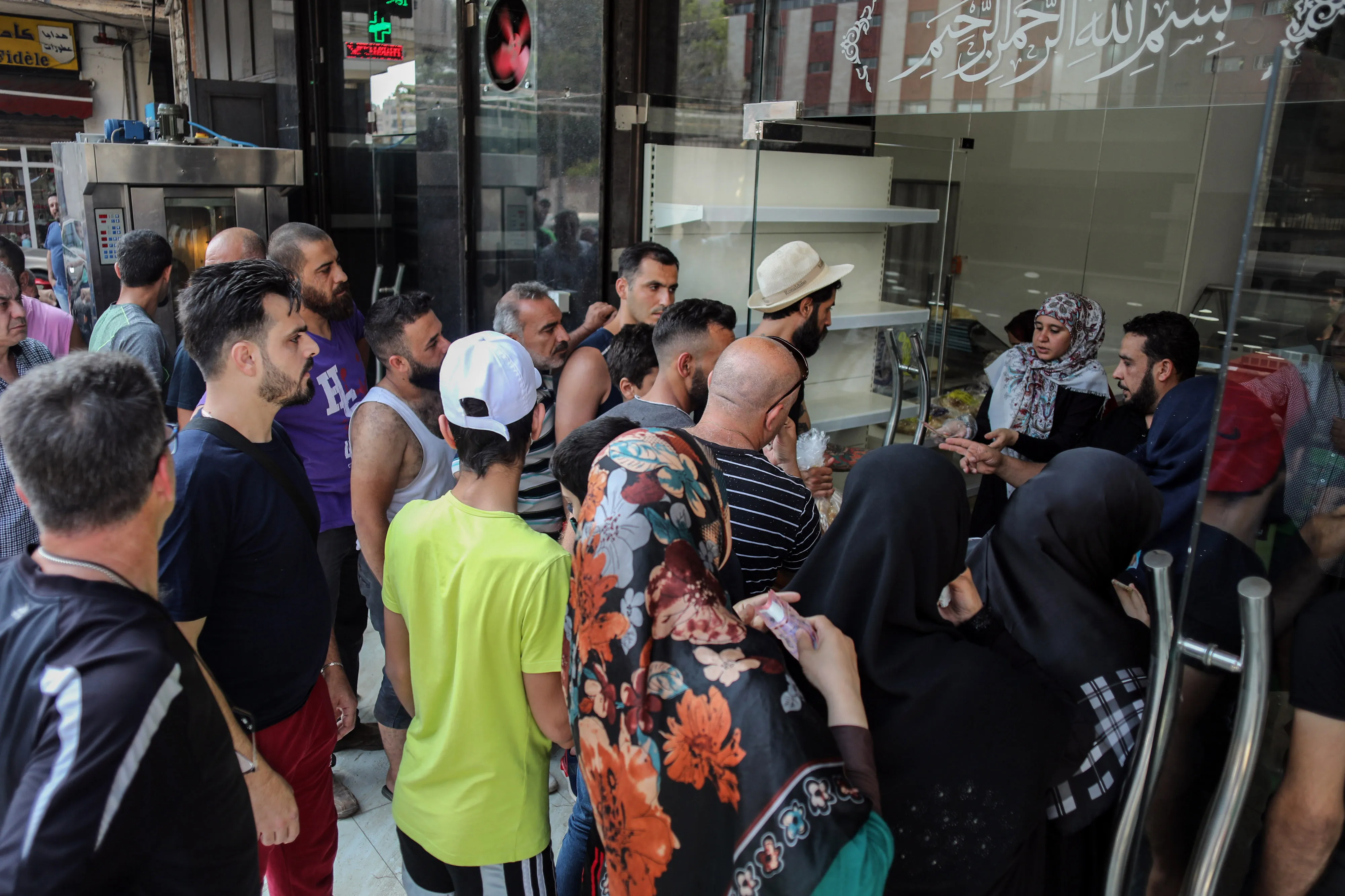 People crowd the entrance to a local bakery to purchase bread in Beirut, Lebanon.