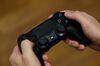 A Sony Corp. PlayStation games controller is held in an arranged photograph in Tokyo.