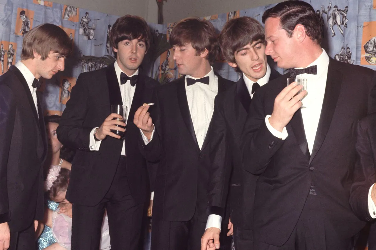 (L-R) Ringo Starr, Paul McCartney, John Lennon (1940-1980) and George Harrison (1943-2001) of the Liverpudlian pop group The Beatles with their manager Brian Epstein (1935-1967) at the premiere of their first film "A Hard Day's Night" on July 6th, 1964. Photographer: Hulton Archive/Getty Images