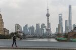 A pedestrian wearing a face-mask walks near the Bund&nbsp;in Shanghai.