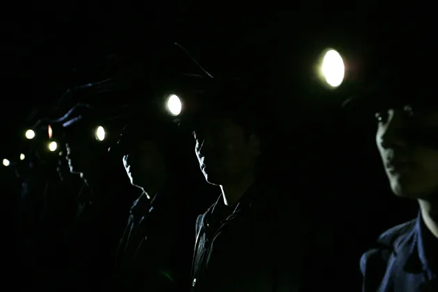 Workers attend a meeting about safety production in a coal pit in Chongqing Municipality, China