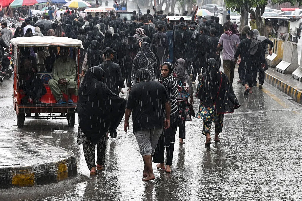 Commuters during heavy rainfall in Lahore, earlier this month.&nbsp;
