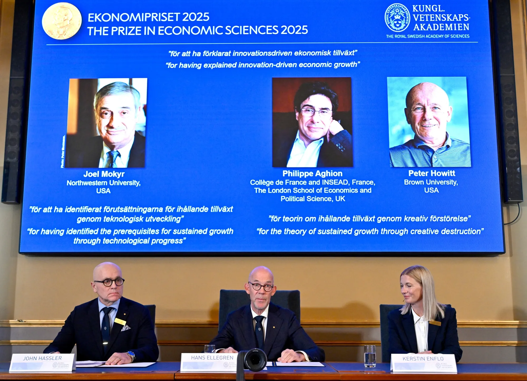 A screen displaying the 2025 Nobel Prize for economics prize winners Joel Mokyr, Philippe Aghion and Peter Howitt, in Stockholm, on Oct. 13.