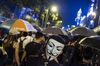 A demonstrator wearing 'anonymous mask, also known as a Guy Fawkes mask, march along Gloucester Road during a protest in the Wan Chai district of Hong Kong, China, on Friday, Oct. 4, 2019. Hong Kong invoked emergency powers for the first time in more than half a century to ban face masks for protesters after months of unrest, prompting demonstrators to occupy downtown streets.