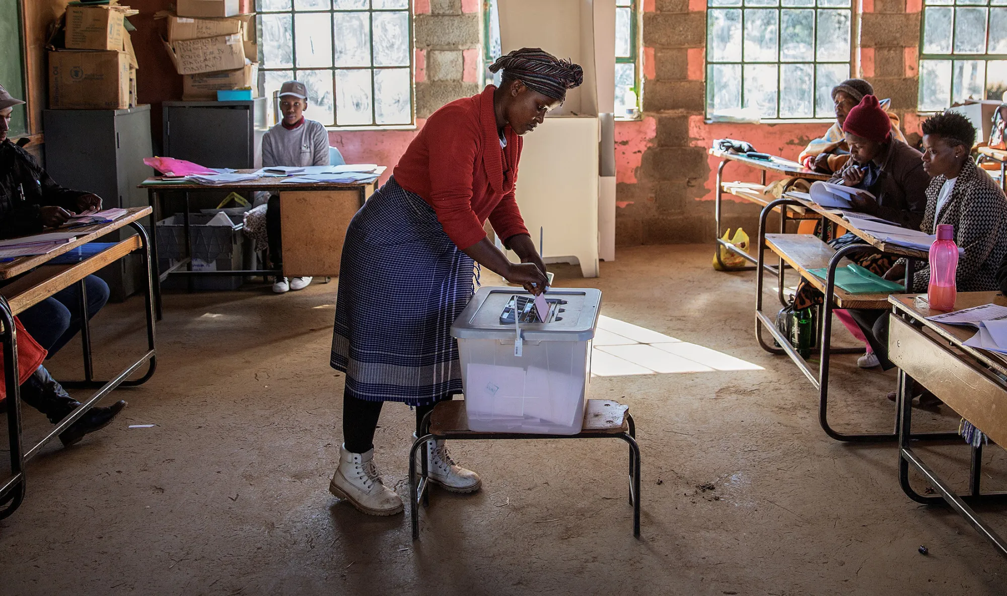 A woman casts her ballot during Lesotho general elections at a polling station on June 3, 2017 in the remote village of Nyakosoba.
