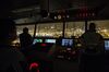 Crew members look out from the control room of CMA CGM SA's Benjamin Franklin container ship as the vessel prepares to dock at the Kwai Tsing Container Terminal in the early morning in Hong Kong, China