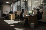A worker speaks with a customer at a service center in the central business district (CBD) of Johannesburg, July 28.