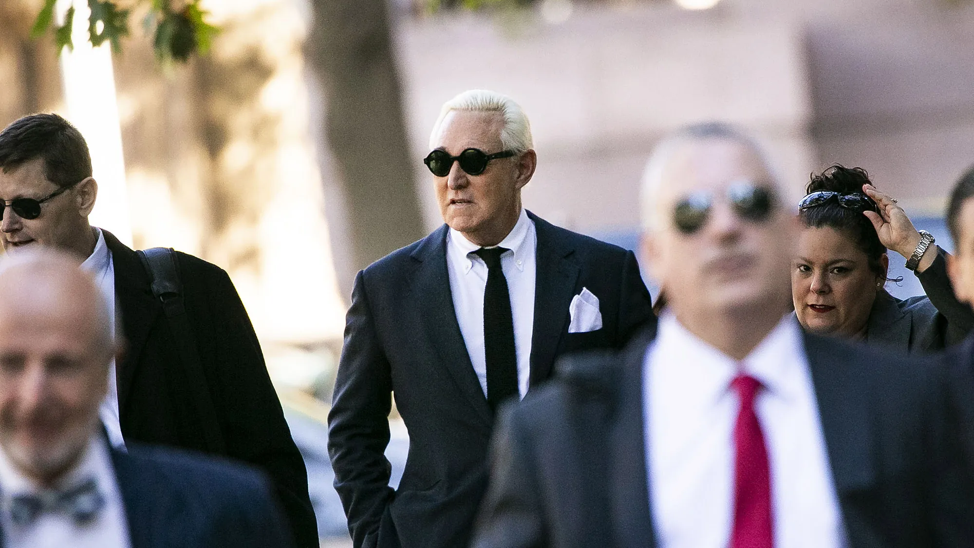 Roger Stone, center, arrives at federal court in Washington on Nov. 4.