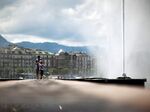 Pedestrians pass the Jet d'Eau water fountain in Geneva, Switzerland.