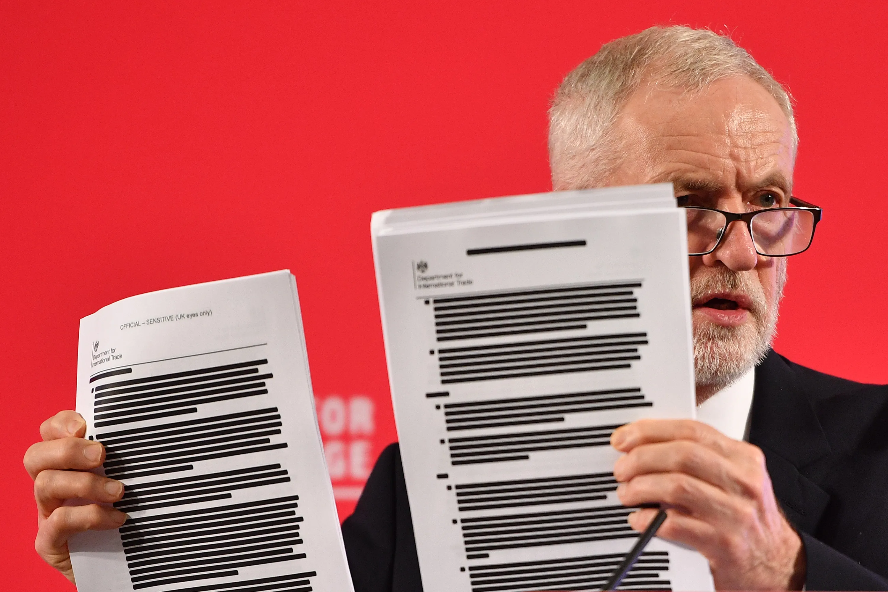 Jeremy Corbyn presents a redacted dossier containing the minutes of early U.S.-U.K. trade negotiations, on Nov. 27.