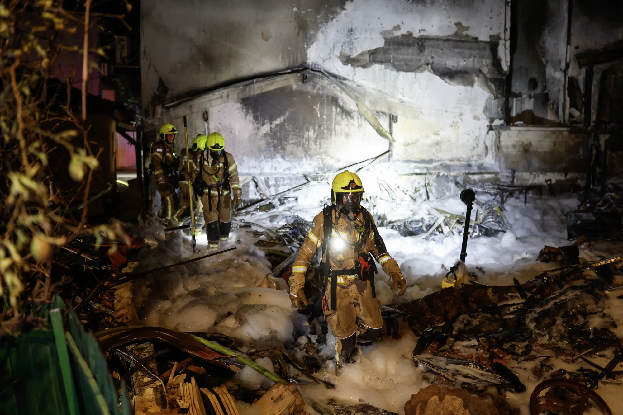 Firefighters work at the site of a strike in&nbsp;Nahariya, Israel,&nbsp;on March 16.