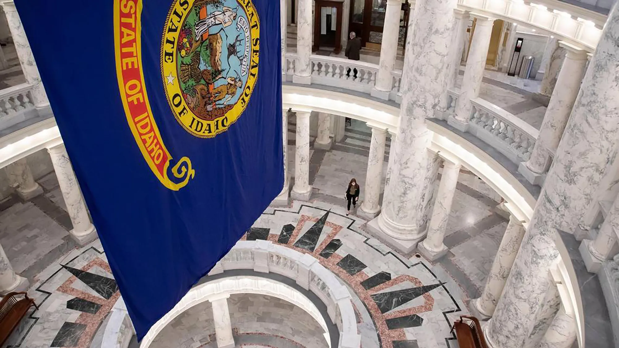The state flag hangs in the statehouse rotunda in Boise, Idaho.