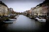 Pleasure boats sit at their moorings near residential buildings on a canal in the Christianshavn district of Copenhagen, Denmark, on Tuesday, March 14, 2017. Denmark has changed the way it conducts monetary policy in response to a 2015 existential crisis, according to Danske Bank A/S, the country’s biggest lender.