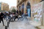 Protesters ram barricades near parliament in Beirut on Feb. 11.