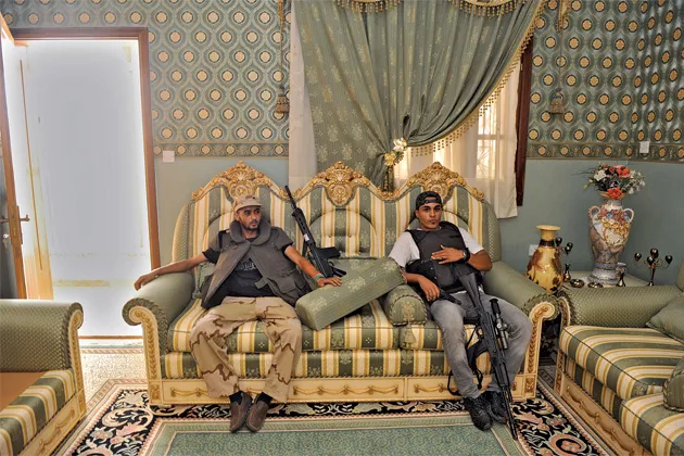 November 2011: After Qaddafi's fall, rebels relax in one of the dictator's palaces