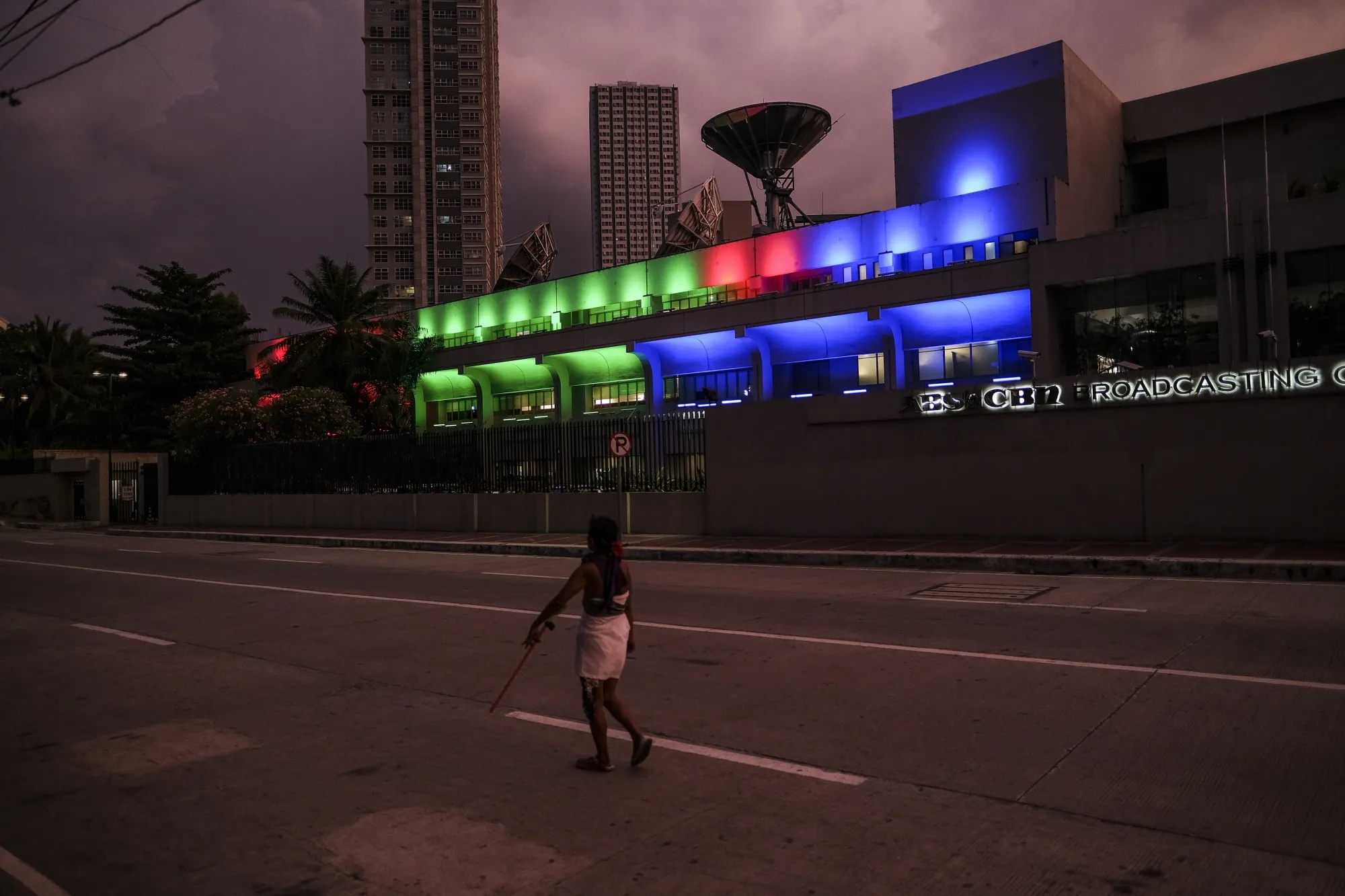 A pedestrian walks past the ABS-CBN Corp. Broadcasting Center&nbsp;in Metro Manila, the Philippines.