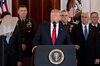U.S. President Donald Trump, center, speaks in the Grand Foyer of the White House in Washington, D.C., U.S., on Wednesday, Jan. 8, 2020.