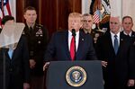 U.S. President Donald Trump, center, speaks in the Grand Foyer of the White House in Washington, D.C., U.S., on Wednesday, Jan. 8, 2020.