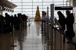Travelers check in for their flights at the Detroit Metropolitan Wayne County Airport in Michigan, U.S.