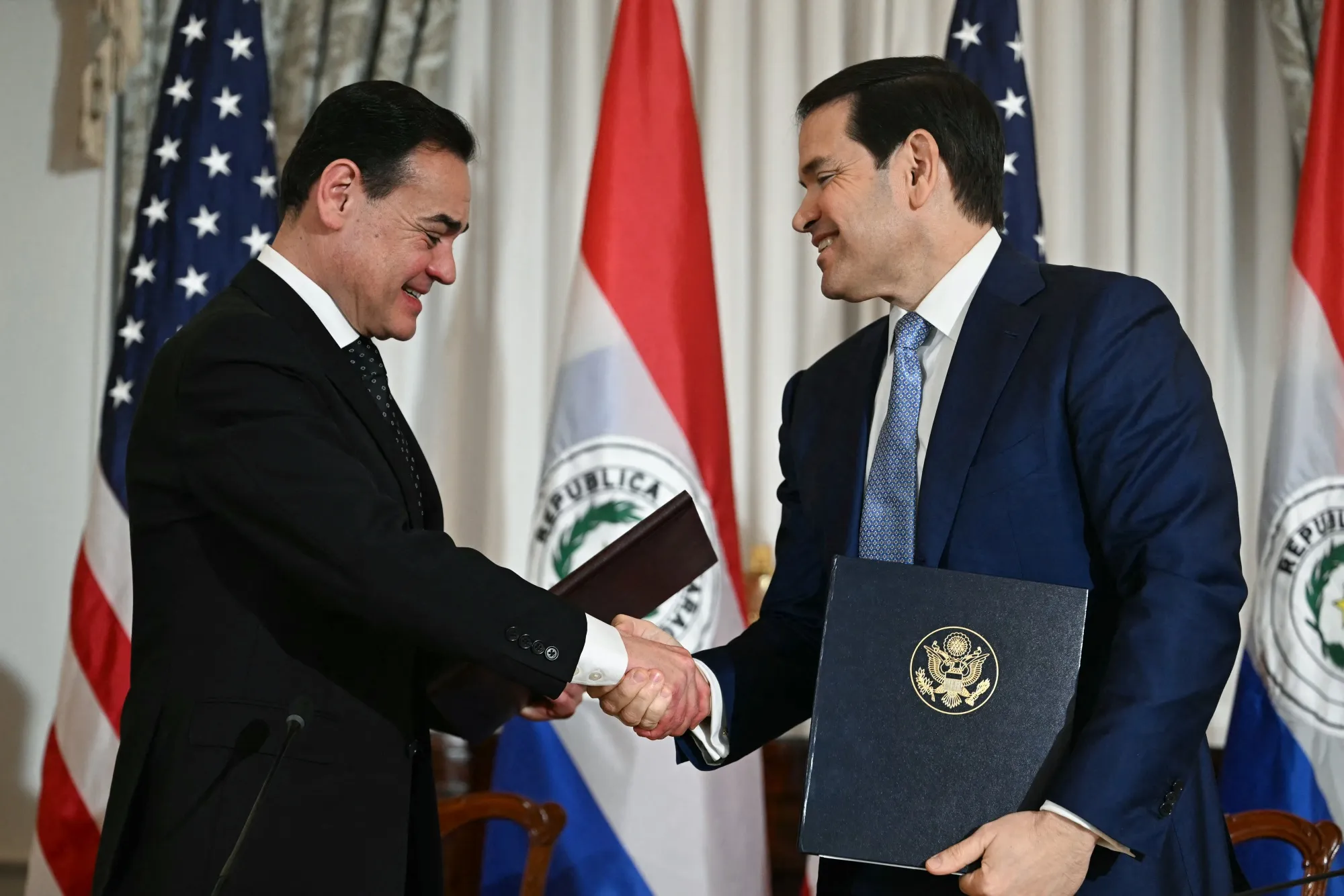 Marco Rubio, right,&nbsp;and&nbsp;Ruben Ramirez shake hands in Washington on Dec. 15.