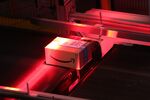 A red light scans a parcel on a conveyor belt inside an Amazon.com Inc. fulfilment center in&nbsp;Germany.