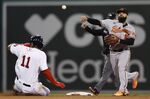 Boston Red Sox's Rafael Devers (11) is forced out at second base as Baltimore Orioles' Rougned Odor throws to first base on the single by Xander Bogaerts during the fourth inning of a baseball game, Tuesday, Sept. 27, 2022, in Boston. Odor made a throwing error on the play. (AP Photo/Michael Dwyer)