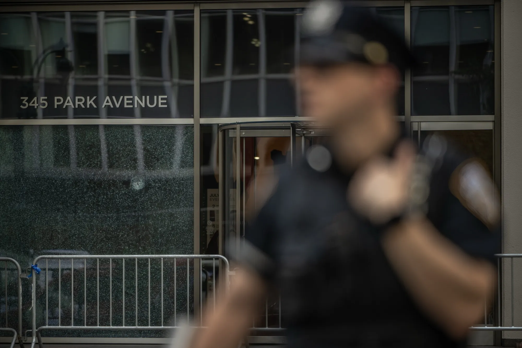 New York Police Department (NYPD) officers secure the scene of a shooting from Monday in New York on July 29.