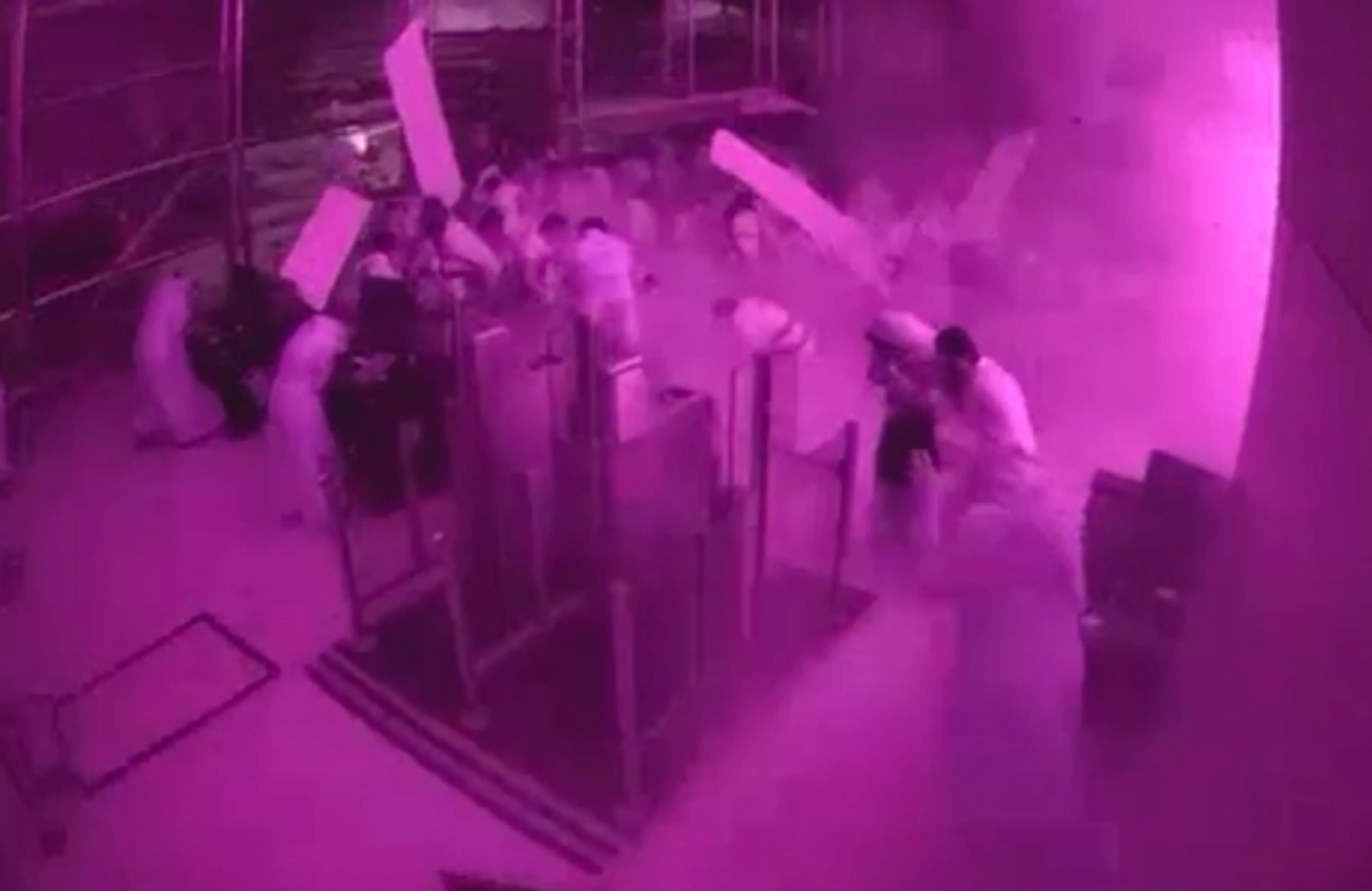 This image from CCTV video released by Saudi Arabia’s Media Ministry shows passengers taking cover as flames and smoke fill part of King Khalid International Airport in Riyadh, Saudi Arabia, during what authorities described as a strike at the airport on Saturday, Oct. 10.