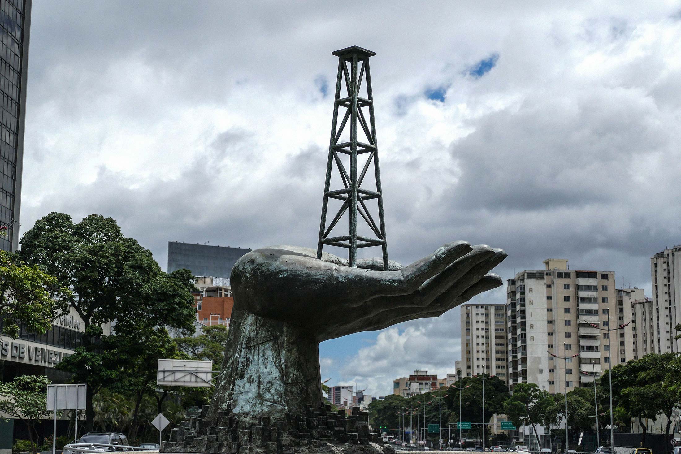 A sculpture&nbsp;depicting an oil derrick in a hand stands outside PDVSA headquarters in Caracas.
