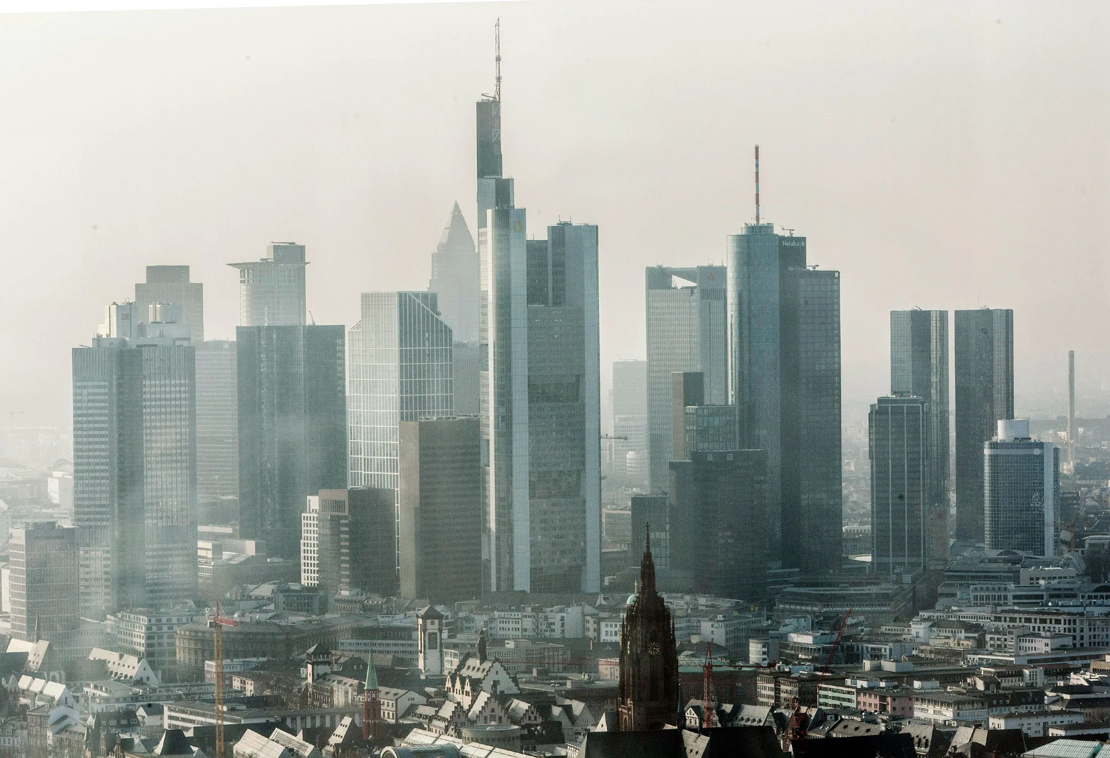 Skyscrapers stand on the city skyline in this photograph taken from the European Central Bank's (ECB) new headquarters in Frankfurt, Germany, on Friday, Feb. 13, 2015.
