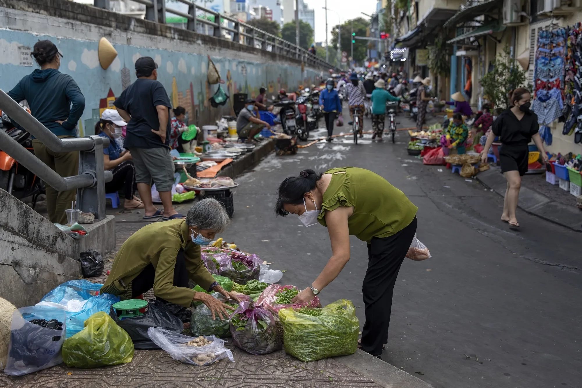 A customer selects vegetables in a market in Ho Chi Minh City on March 28.