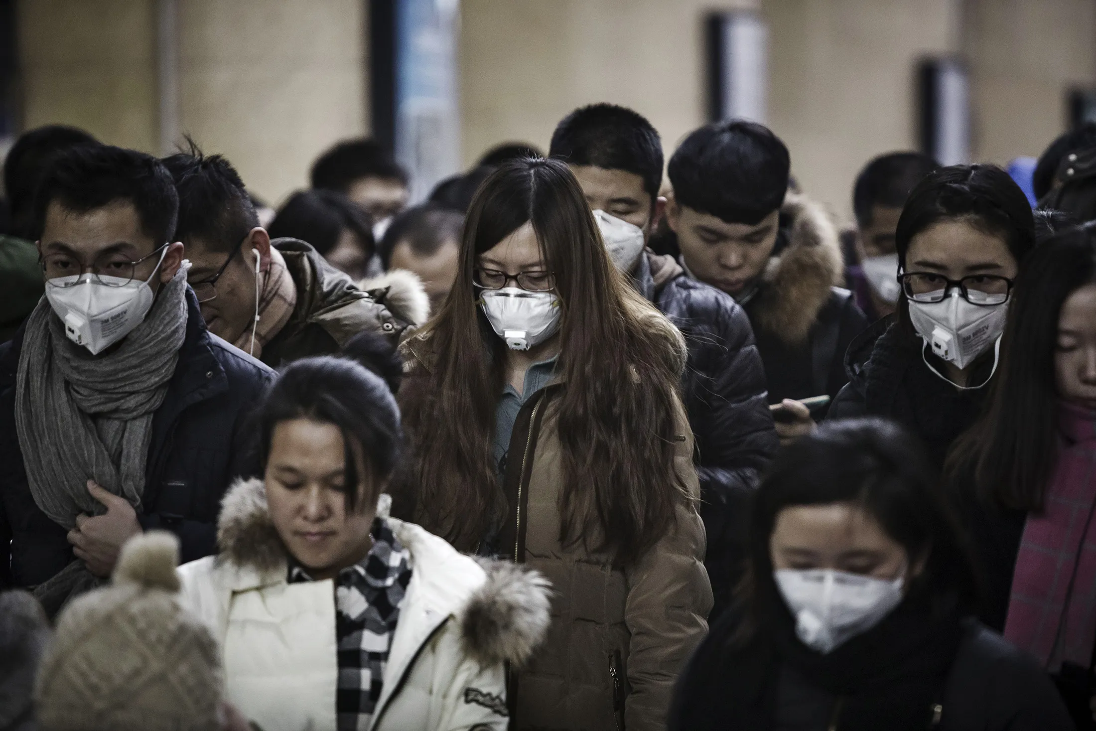 Passengers wearing face masks walk through a subway station in Beijing, China, on Jan. 6.
